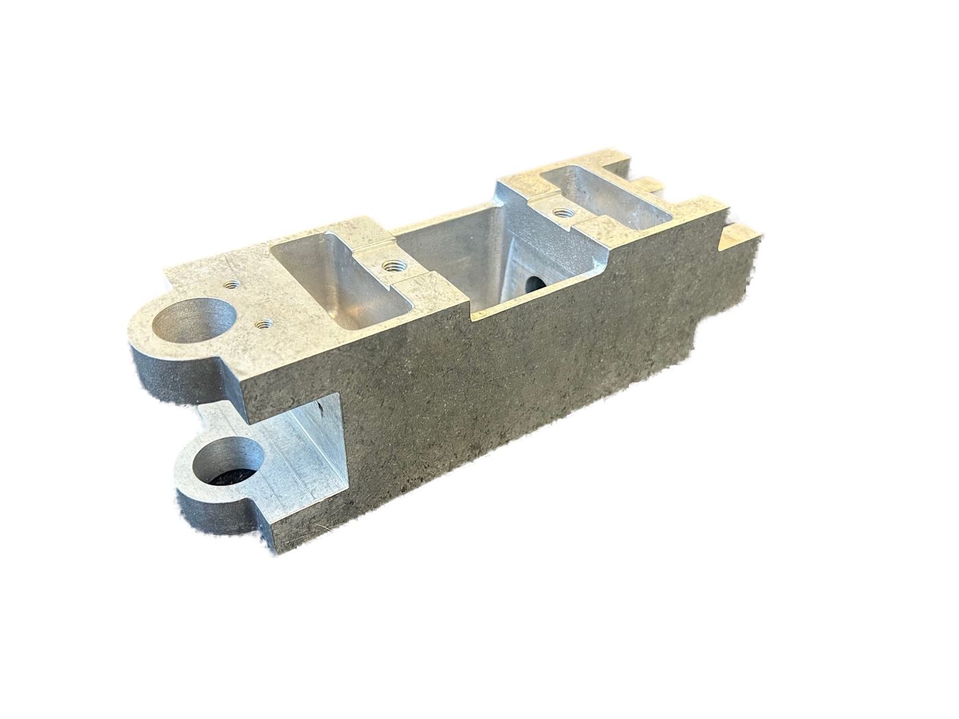 Gravity die cast bracket component with two bosses